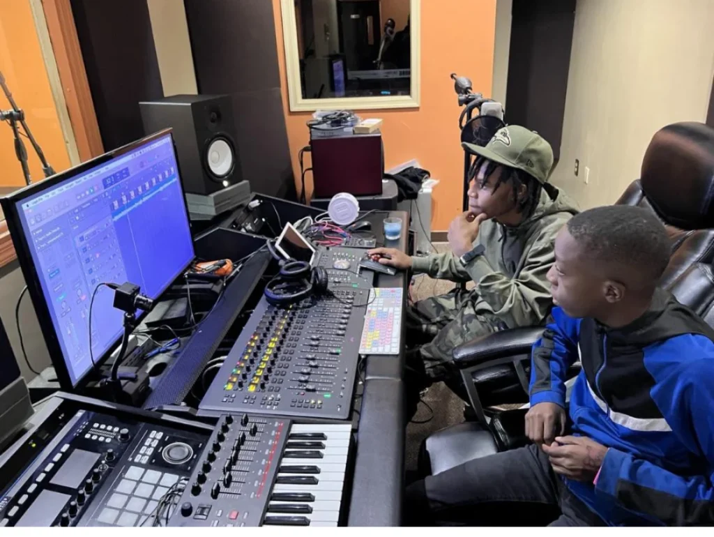 A young producer working in the Reed's Refuge media studio