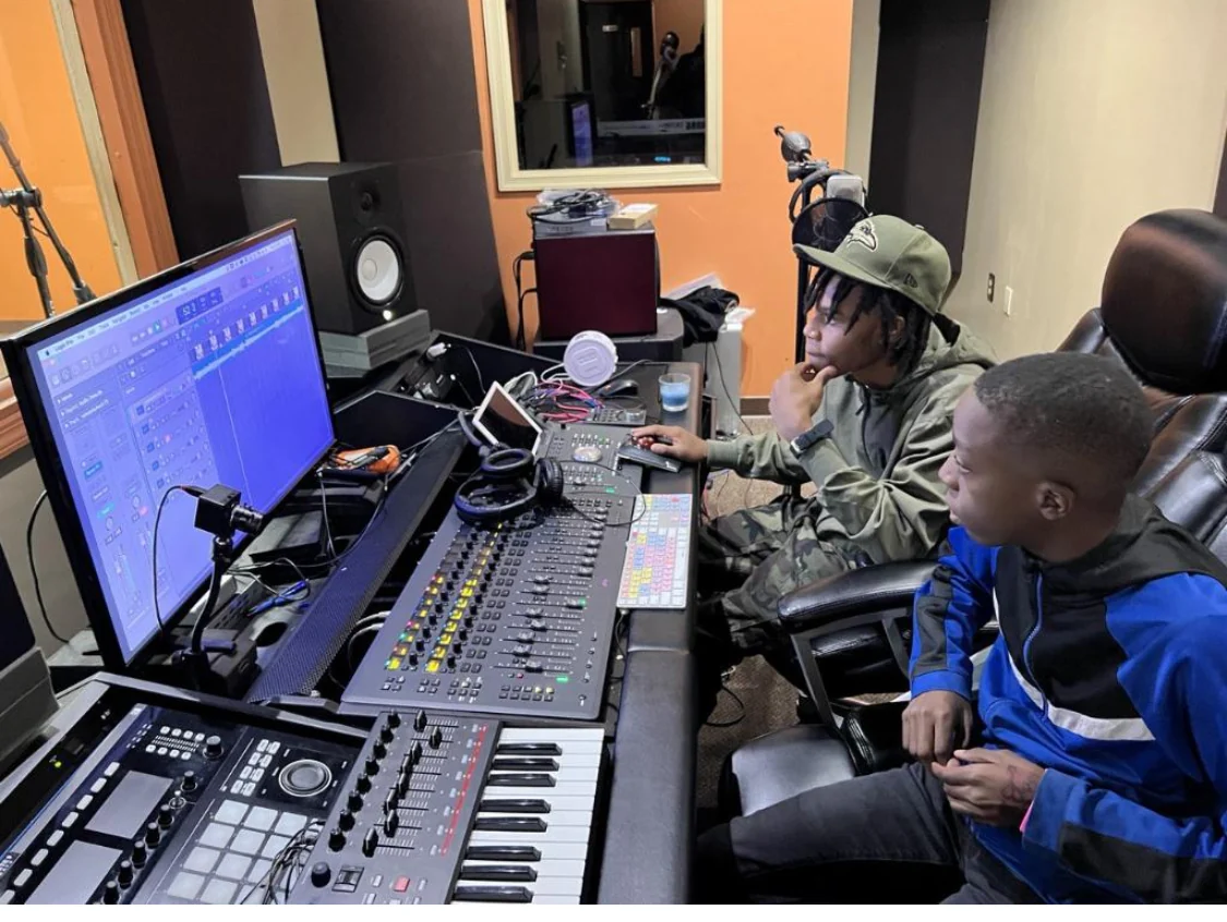 A young producer working in the Reed's Refuge media studio