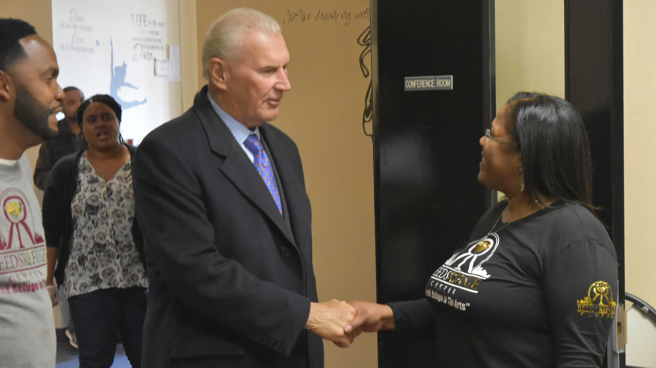 Reed’s Refuge leaders welcoming a community visitor to the center