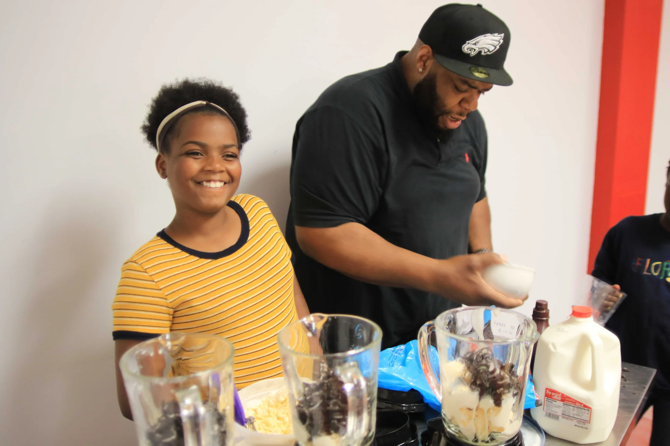 A young participant preparing a drink with a mentor during Cooking Without a Stove