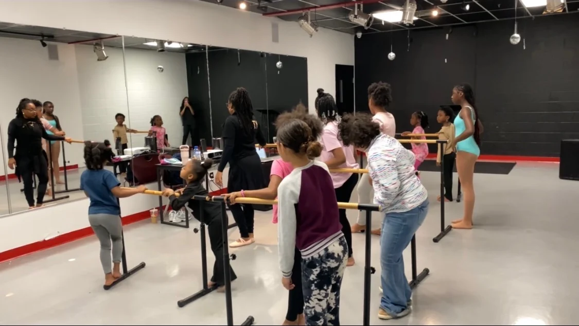 Young people practising at the barre during a Reed’s Refuge dance class