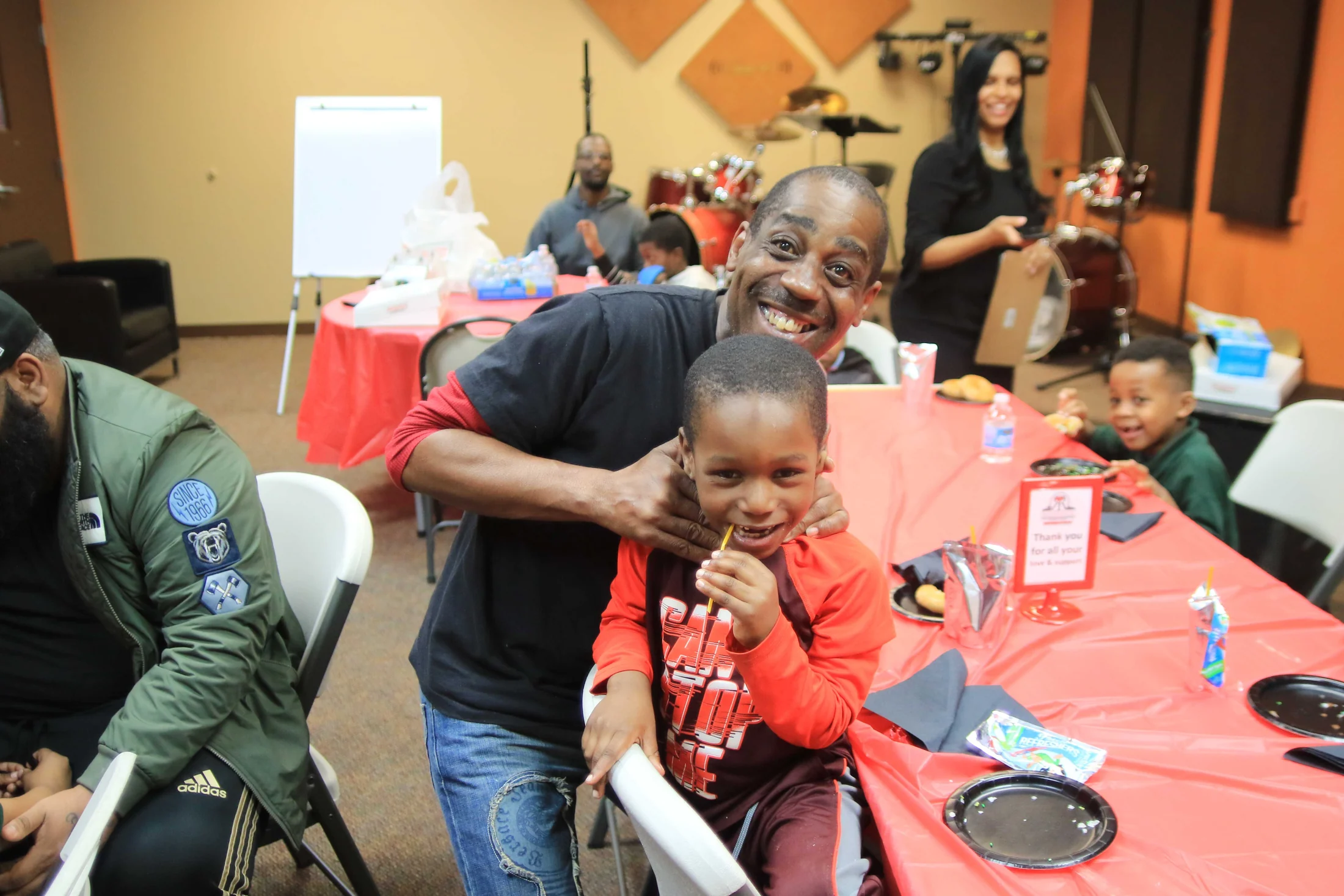 A parent and child spending time together at a Reed’s Refuge family event