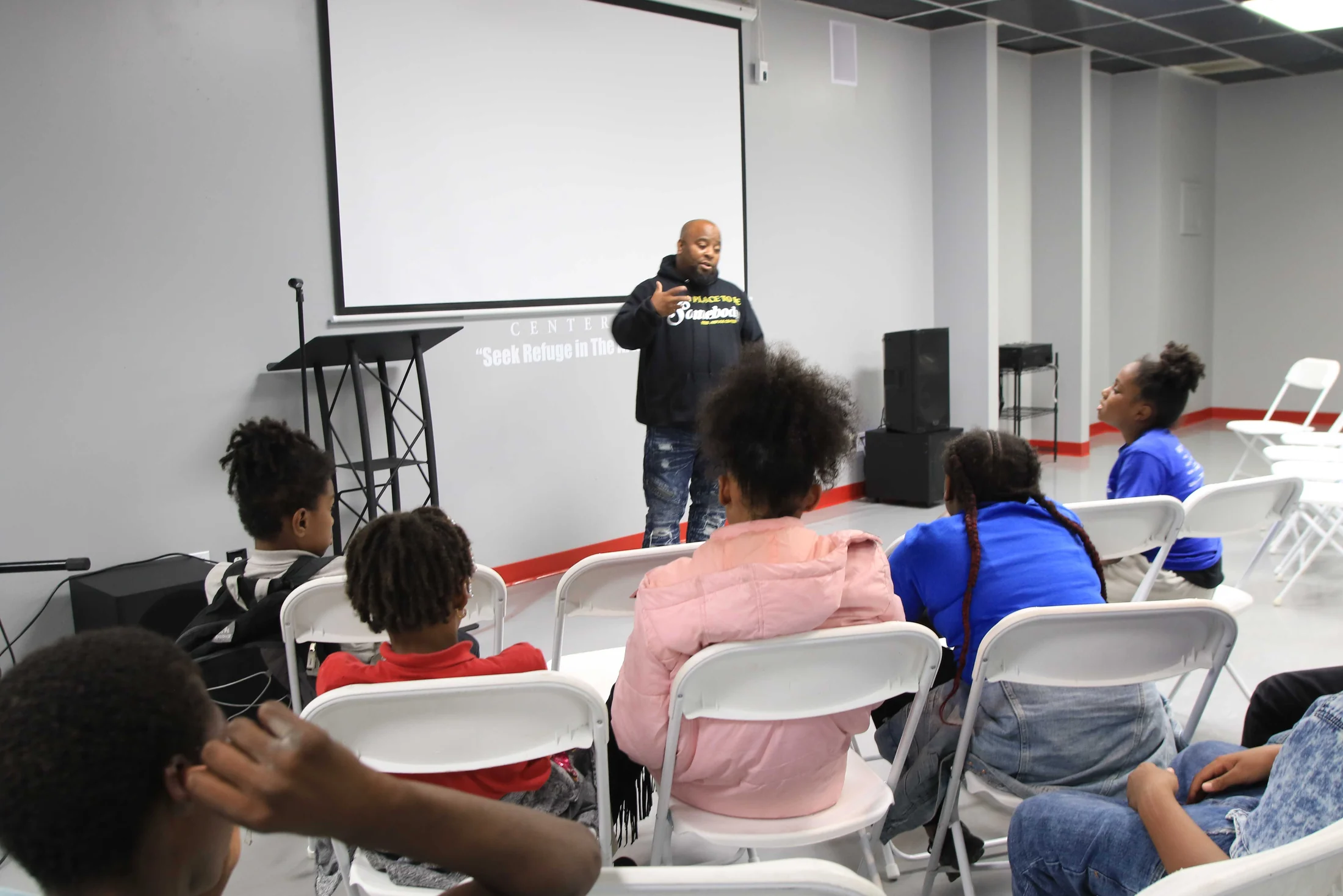 A group taking part in a presentation and discussion at Reed’s Refuge Center