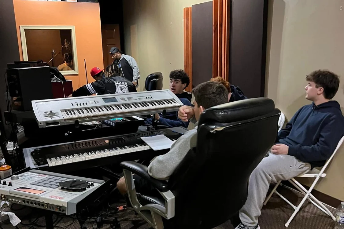 Young people exploring music production and keyboards in the Reed’s Refuge studio