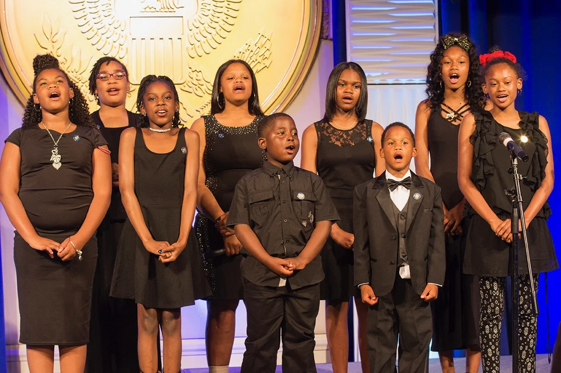 Reed’s Refuge youth choir performing together on stage