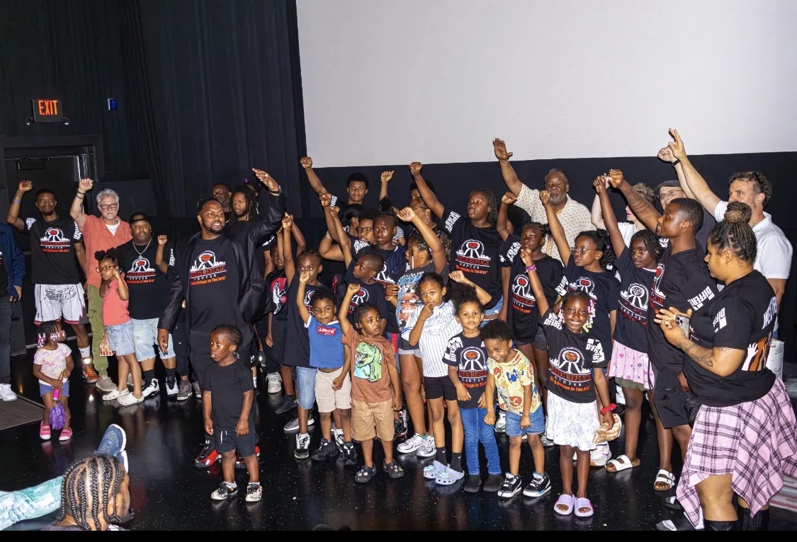 Reed’s Refuge youth and mentors celebrating together on stage